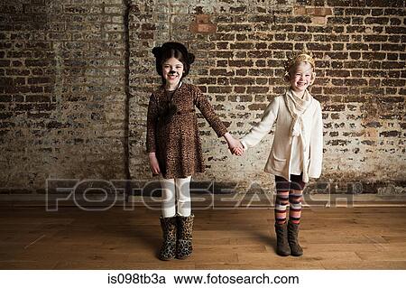 Young girls dressed up as cat and queen, holding hands View Large Photo Image Stock Image - Young girls dressed up as cat and queen, holding hands. Fotosearch