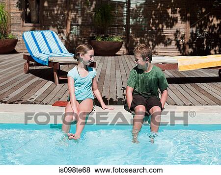 Boy and girl on edge of swimming pool View Large Photo Image Stock Photo - Boy and girl on edge of swimming pool. Fotosearch