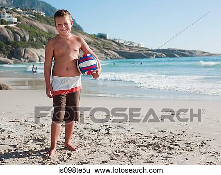 Stock Photograph - Boy on a beach with ball. Fotosearch