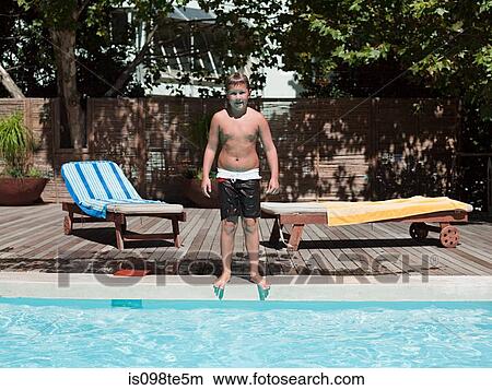 Boy on edge of swimming pool View Large Photo Image Picture - Boy on edge of swimming pool. Fotosearch