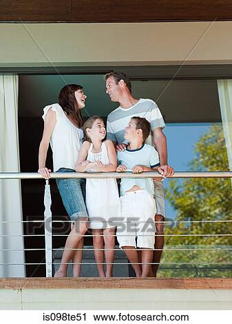 Family on balcony of holiday home View Large Photo Image Stock Image - Family on balcony of holiday home. Fotosearch