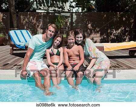 Family sitting on edge of swimming pool View Large Photo Image Stock Image - Family sitting on edge of swimming pool. Fotosearch
