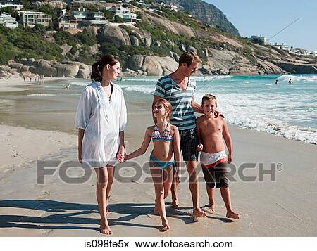 Family walking on a beach View Large Photo Image Stock Photo - Family walking on a beach. Fotosearch
