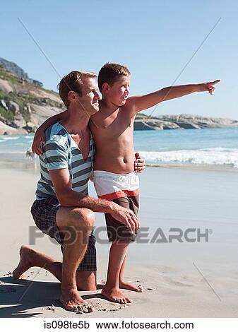 Father and son on beach View Large Photo Image Stock Image - Father and son on beach. Fotosearch