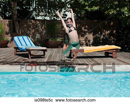 Girl jumping into swimming pool View Large Photo Image Stock Image - Girl jumping into swimming pool. Fotosearch