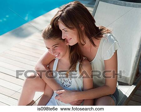 Stock Image - Mother and daughter by pool. Fotosearch