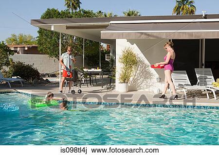 Stock Image - Family and outdoor swimming pool. Fotosearch