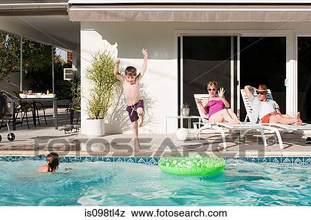 Stock Photo - Family and outdoor swimming pool. Fotosearch