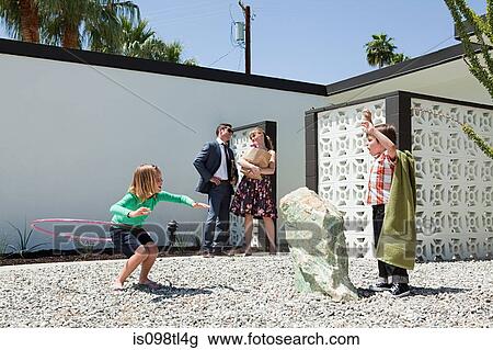 Stock Image - Family playing outside home. Fotosearch