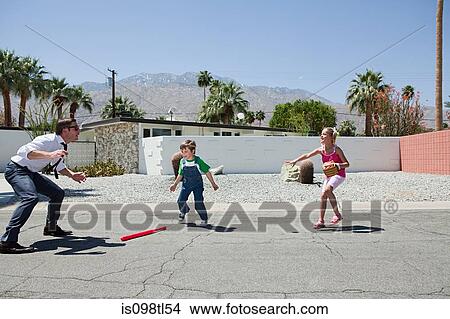Father playing ball with son and daughter View Large Photo Image Picture - Father playing ball with son and daughter. Fotosearch