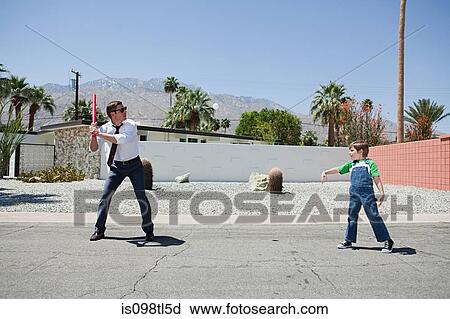 Father playing ball with son View Large Photo Image Stock Image - Father playing ball with son. Fotosearch