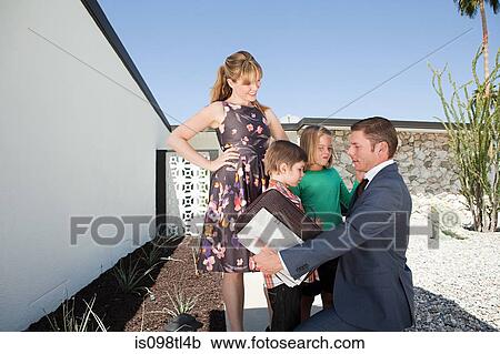 Stock Image - Father saying goodbye to family. Fotosearch