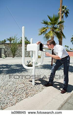 Man looking into mailbox View Large Photo Image Stock Photography - Man looking into mailbox. Fotosearch