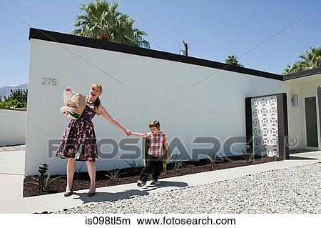 Mother holding shopping bag and pulling son's arm View Large Photo Image Picture - Mother holding shopping bag and pulling son's arm. Fotosearch