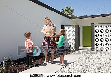 Mother with two children outside home View Large Photo Image Stock Image - Mother with two children outside home. Fotosearch
