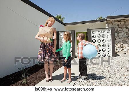 Mother with two children outside home View Large Photo Image Stock Photograph - Mother with two children outside home. Fotosearch