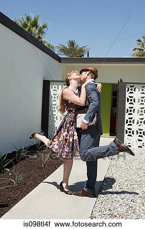 Stock Image - Retro couple outside home. Fotosearch
