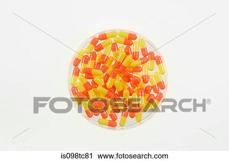 Stock Image - Capsules in a petri dish. Fotosearch