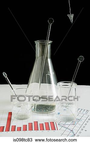 Flask and beakers on graphs View Large Photo Image Stock Image - Flask and beakers on graphs. Fotosearch