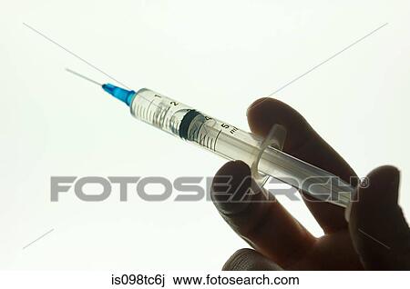 Person holding syringe View Large Photo Image Stock Image - Person holding syringe. Fotosearch