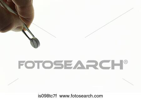 Person holding tablet with tweezers View Large Photo Image Stock Image - Person holding tablet with tweezers. Fotosearch