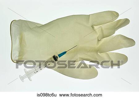 Stock Photograph - Syringe and surgical glove. Fotosearch