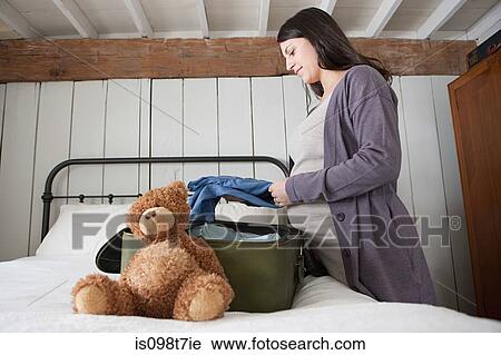 Expectant mother packing suitcase View Large Photo Image Stock Image - Expectant mother packing suitcase. Fotosearch