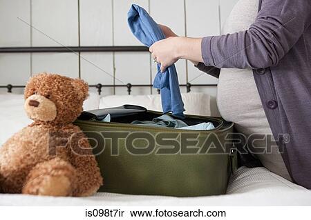 Expectant mother packing suitcase View Large Photo Image Stock Photography - Expectant mother packing suitcase. Fotosearch