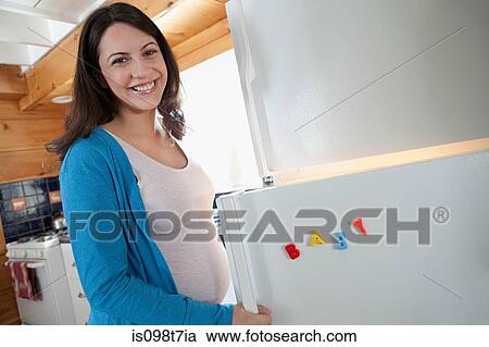 Pregnant woman by refrigerator View Large Photo Image Stock Image - Pregnant woman by refrigerator. Fotosearch