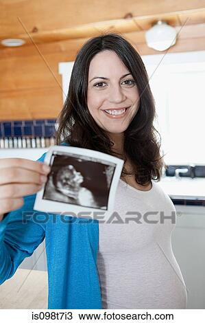Pregnant woman with ultrasound scan View Large Photo Image Stock Image - Pregnant woman with ultrasound scan. Fotosearch