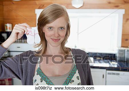 Woman holding baby socks View Large Photo Image Stock Photo - Woman holding baby socks. Fotosearch