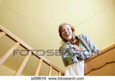 Woman looking in to crib View Large Photo Image Picture - Woman looking in to crib. Fotosearch