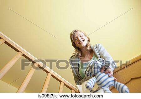 Woman looking in to crib View Large Photo Image Stock Image - Woman looking in to crib. Fotosearch