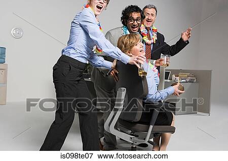 Business people enjoying office party View Large Photo Image Stock Photo - Business people enjoying office party. Fotosearch