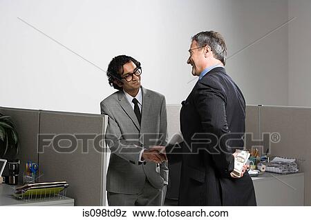 Stock Photo - Businessman holding money behind his back. Fotosearch