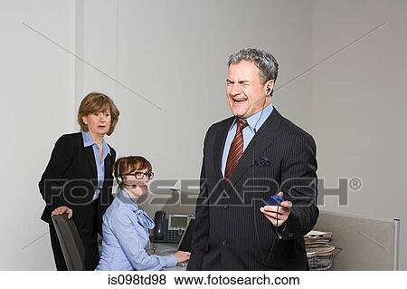 Businessman listening to MP3 player View Large Photo Image Stock Photo - Businessman listening to MP3 player. Fotosearch