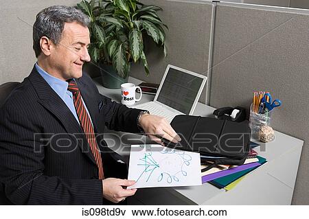 Stock Photo - Businessman with doodle at desk. Fotosearch