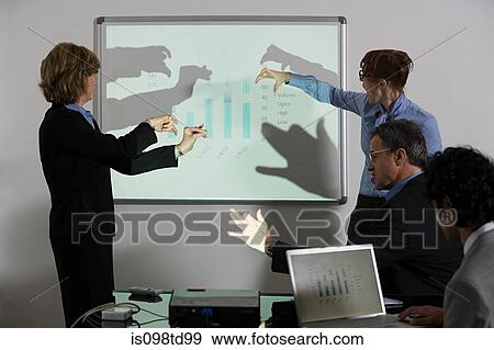 Businesspeople doing shadow puppets in front of whiteboard View Large Photo Image Stock Photo - Businesspeople doing shadow puppets in front of whiteboard. Fotosearch