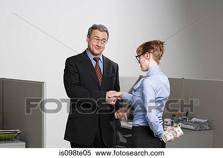 Stock Photography - Businesswoman holding money behind her back. Fotosearch