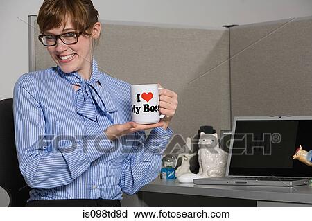 Stock Image - Businesswoman holding slogan mug. Fotosearch