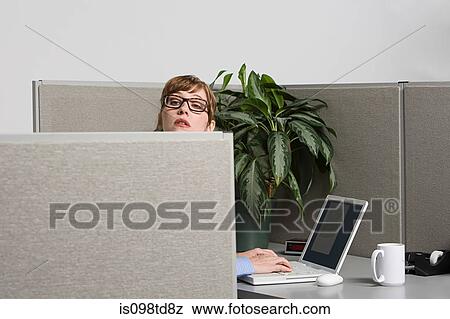 Stock Photo - Businesswoman peeking over screen. Fotosearch