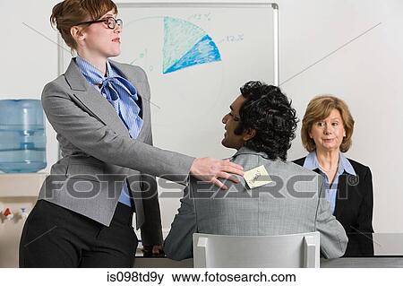 Businesswoman sticking adhesive note to man's back View Large Photo Image Stock Photo - Businesswoman sticking adhesive note to man's back. Fotosearch
