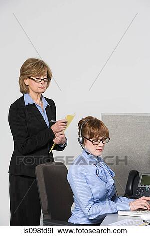 Businesswoman watching over work View Large Photo Image Stock Image - Businesswoman watching over work. Fotosearch