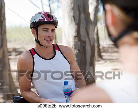Young couple cycling View Large Photo Image Stock Image - Young couple cycling. Fotosearch