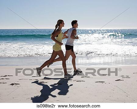 Young couple jogging on beach View Large Photo Image Stock Photography - Young couple jogging on beach. Fotosearch