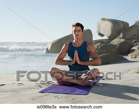 Young man doing yoga on beach View Large Photo Image Stock Photograph - Young man doing yoga on beach. Fotosearch
