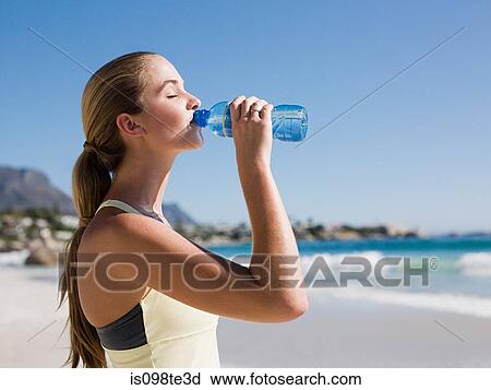 Young woman drinking water View Large Photo Image Stock Image - Young woman drinking water. Fotosearch