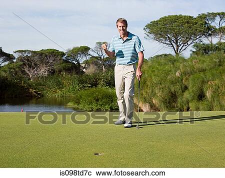 Stock Image - Ecstatic man playing golf. Fotosearch