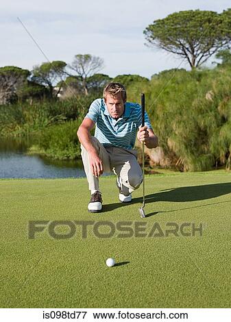 Man playing golf, on putting green View Large Photo Image Stock Photo - Man playing golf, on putting green. Fotosearch