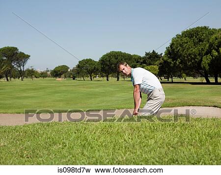 Man playing golf, stuck in bunker View Large Photo Image Stock Photo - Man playing golf, stuck in bunker. Fotosearch